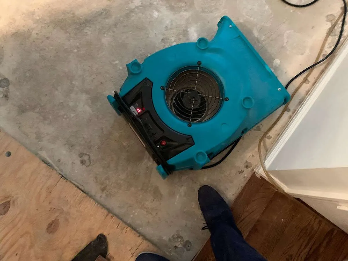 Air mover drying subfloor during Leak Detection & Repair in California